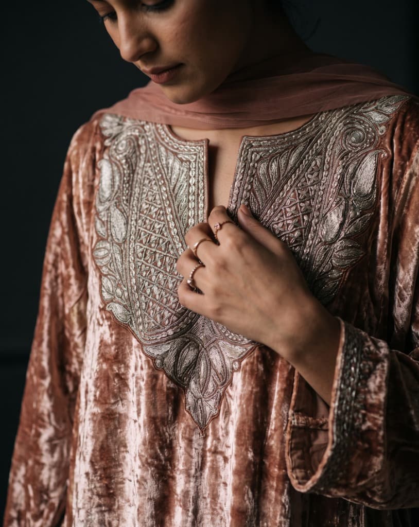 Woman wearing the bespoke Kashmiri winter embroidered crushed velvet pheran